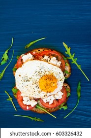 Sandwich With Feta Cheese And Tomatoes, Fried Eggs For Breakfast. Dark Background, Top View