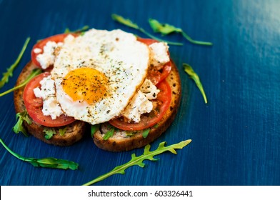 Sandwich With Feta Cheese And Tomatoes, Fried Eggs For Breakfast. Dark Background, Top View