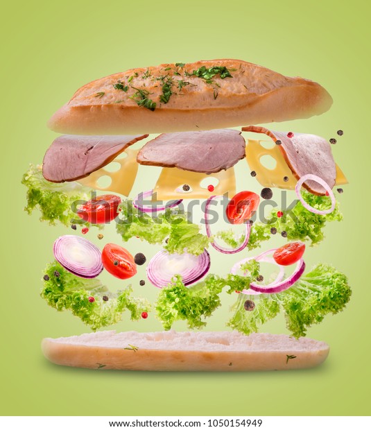 Sandwich with flying ingredients. Freeze\
motion. Close-up. yellow\
background