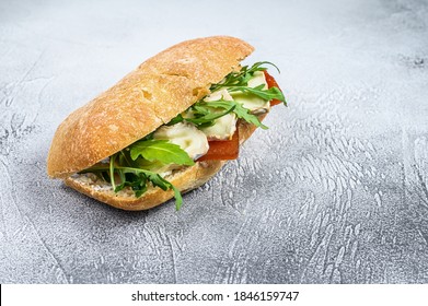 Sandwich with fresh Camembert cheese, pear marmalade, ricotta and arugula. Gray background. Top view. Space for text