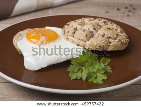 Sandwich with a fried egg on a wooden table dark.