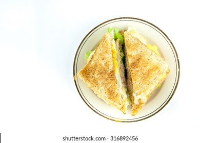 Sandwich Full Of Tuna And Lettuce Vegetables Sliced In Half And Decorated On The Plate -  Top View