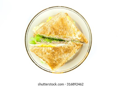 Sandwich Full Of Tuna And Lettuce Vegetables Sliced In Half And Decorated On The Plate -  Top View