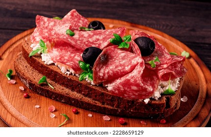 Sandwich , grain bread, with cream cheese and salami, black olives, micro-greens, top view, close-up, no people, Breakfast,
