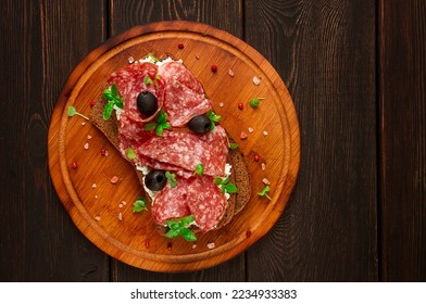 Sandwich , grain bread, with cream cheese and salami, black olives, micro-greens, top view, close-up, no people, Breakfast,