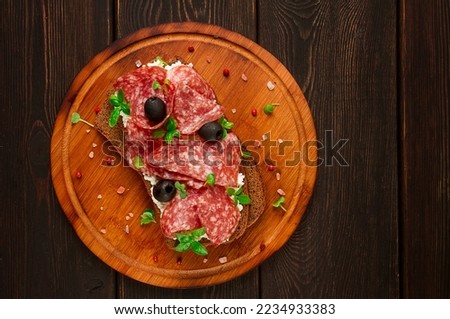 Sandwich , grain bread, with cream cheese and salami, black olives, micro-greens, top view, close-up, no people, Breakfast,