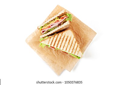 Sandwich With Ham, Cheese, Tomatoes, Lettuce, And Toasted Bread. Top View Isolated On White Background.