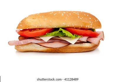 Sandwich With Ham, Turkey, Roast Beef, Lettuce, Tomato And Cheese On A White Hoagie Bun On A White Background