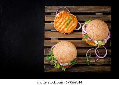 Sandwich juicy spicy chicken burgers with tomato and eggplant. Flat lay. Top view