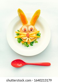 Sandwich Made And Garnished In The Shape Of Rabbit Face To Attract Children. The Sandwich Is Made Of Bred Slice, Papaya, Tomato, Banana And Coriander Leaf. It Is Placed In A White Plate.