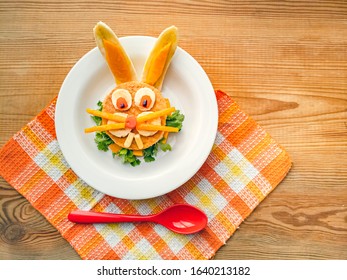 Sandwich Made And Garnished In The Shape Of Rabbit Face To Attract Children. The Sandwich Is Made Of Bred Slice, Papaya, Tomato, Banana And Coriander Leaf. It Is Placed In A White Plate.