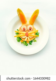 Sandwich Made And Garnished In The Shape Of Rabbit Face To Attract Children. The Sandwich Is Made Of Bred Slice, Papaya, Tomato, Banana And Coriander Leaf. It Is Placed In A White Plate.