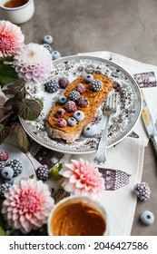 Sandwich With Peanut Butter And Frozen Berries On A Vintage Plate On The Table With Flowers And Leaves. Light Breakfast.