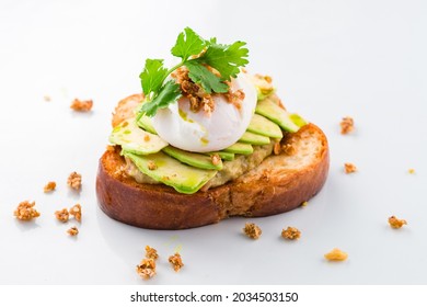 sandwich with poached egg and avocado isolated on a white background, Whole wheat toasted bread with avocado and poached egg. healthy breakfast concept. Healthy food and diet concept