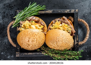 Sandwich With Pulled Pork Meat And Coleslaw Salad. Black Background. Top View