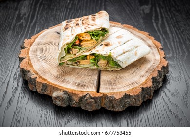 Sandwich Roll With Fish Fingers, Cheese And Vegetables Close-up On The Table. Horizontal View From Above