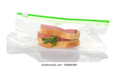 Sandwich With Sausage In A Plastic Bag Isolated On White Background.