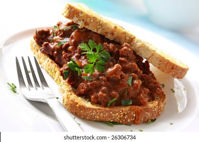 Sandwich Of Savory Ground Beef On Toasted Wholewheat Bread.  A Delicious Variety Of A Sloppy Joe.