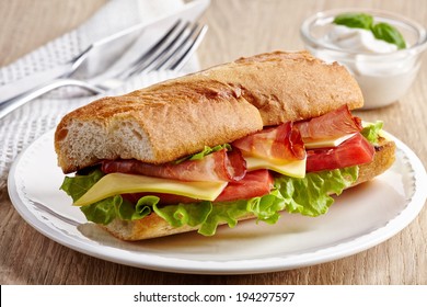 Sandwich With Serrano Ham And Vegetables On White Plate