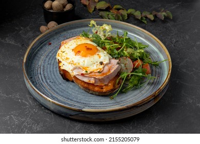 Sandwich With Sunny Side Egg And Ham With Salad On Plate