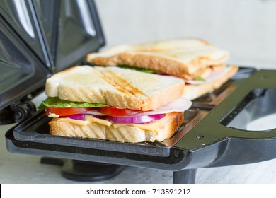 Sandwich Toaster With Toast And Ingredients