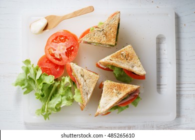 Sandwich Of Whole Wheat Bread With Ham, Cheese And Fresh Tomato, Triangle Cut, Top View