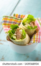 Sandwich Wrap With Tuna Fish, Lettuce And Cucumber, On A Wooden Blue Table