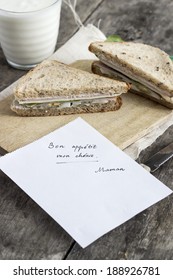 Sandwich And Yogurt With Post It Note On Table