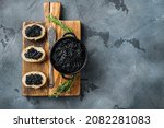 Sandwiches with black caviar and butter, on gray background, top view flat lay  with copy space for text
