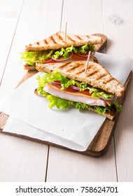  Sandwiches with ham, cheese, tomatoes and  salad with toasted bread.