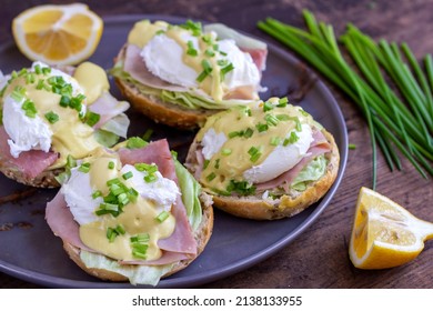 Sandwiches With Poached Egg, Ham, Lettuce, And Chives, Topped With Sauce. Eggs Benedict