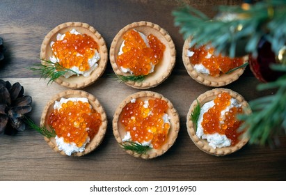 Sandwiches With Red Caviar On A Wooden Plate Near The Christmas Tree. Top Down View