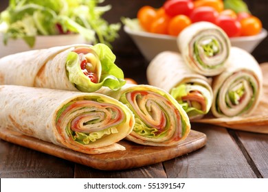 Sandwiches twisted roll tortilla wraps with ham cheese and vegetables 