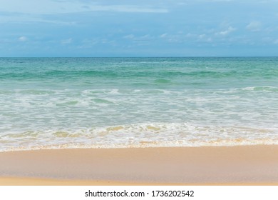 sandy beach blue sky and white foamy wave at Naiharn beach, Phuket island.