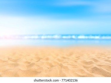 Sandy Beach With Blurry Blue Ocean