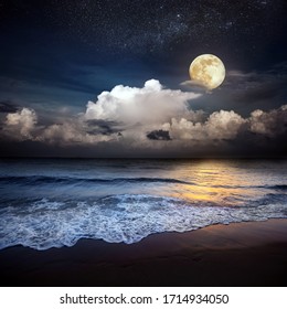 Sandy beach and moon at night
