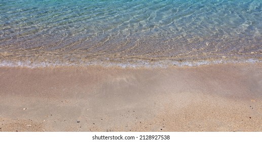 Sandy Beach, Ocean Sea Water Touch Wet Sand Close Up. Greece Summer Vacation Destination