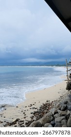 Sandy Beach with Ocean Waves and Cloudy Sky Landscape