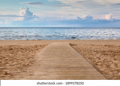 Sandy Beach On Sunny Day With Wooden Walkway