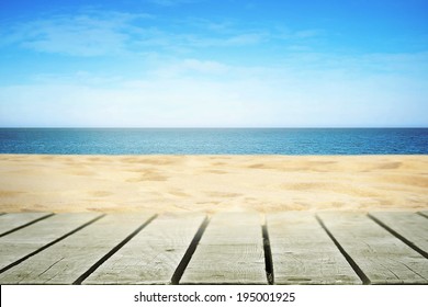 Sandy beach on sunny day with wooden walkway