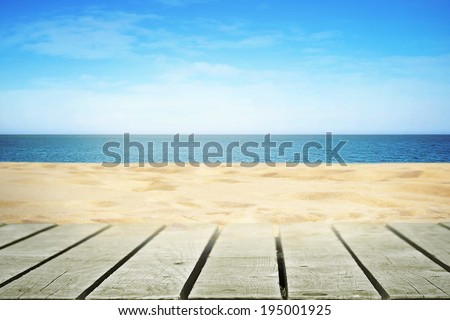 Sandy beach on sunny day with wooden walkway