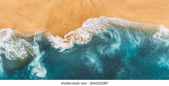 Sandy beach, panorama. Panoramic view of the sandy beach. The sea wave rolls on the shore. Sea coast view from the air. Aerial photography of the sea wave. The ocean and beach. Copy space - Powered by Shutterstock