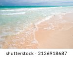 Sandy beach and sea waves, Atlantic ocean coast of Haiti island, Dominican republic. Coastal Caribbean landscape taken on a sunny day at Bavaro beach 