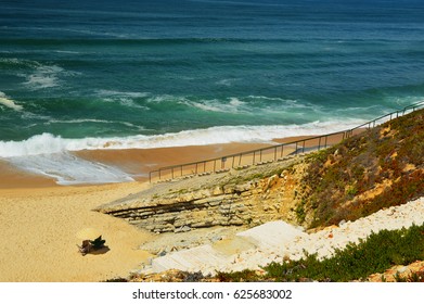 sandy beach under cliffs