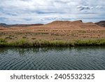 Sandy buttes rise behind the Owyhee River, southwestern Oregon, USA