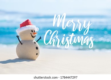 Sandy Christmas Snowman Is Celebrating Christmas On A Beautiful Beach With Merry Christmas Wishes In The Background