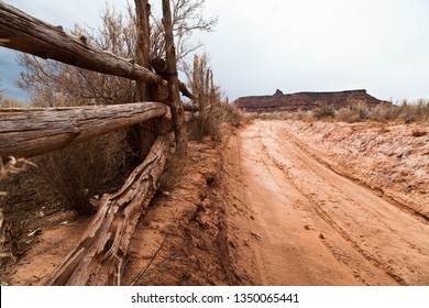 Sandy Dirt Road Next To Rustic Wooden Fence In Utah Desert