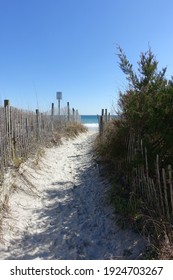 Sandy Path (Public Access Point) Leads to Wrightsville Beach Surrounded by Grass and Weathered Fencing