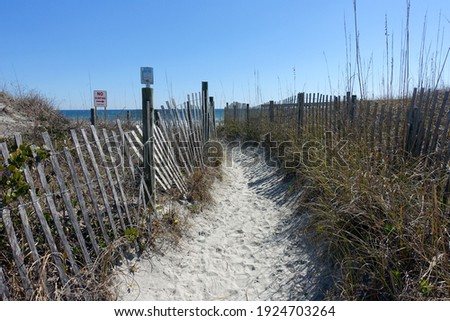 Sandy Path (Public Access Point) Leads to Wrightsville Beach Surrounded by Grass and Weathered Fencing
