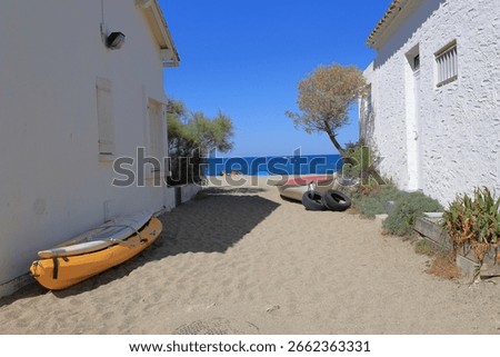 Sandy pathway between cottages leads to the Le Racou beach in Argeles sur Mer,  France.